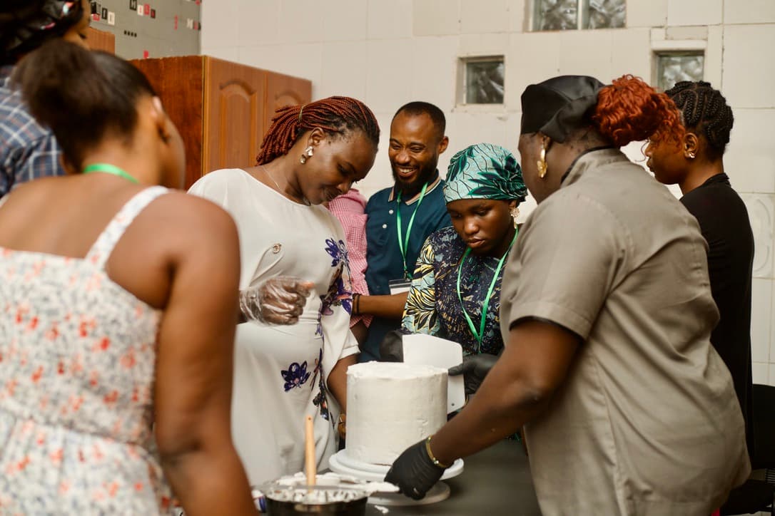 Participants learning cake decorating during a CFO skills workshop