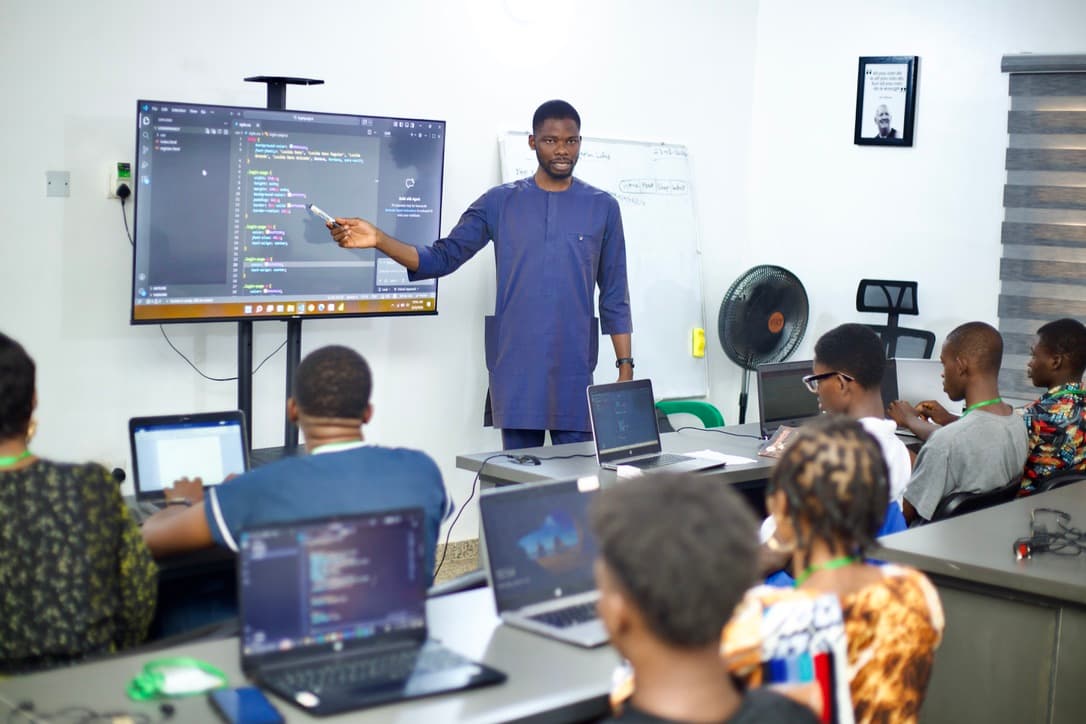 CFO Skill Scale-Up classroom training with instructor and students coding on laptops