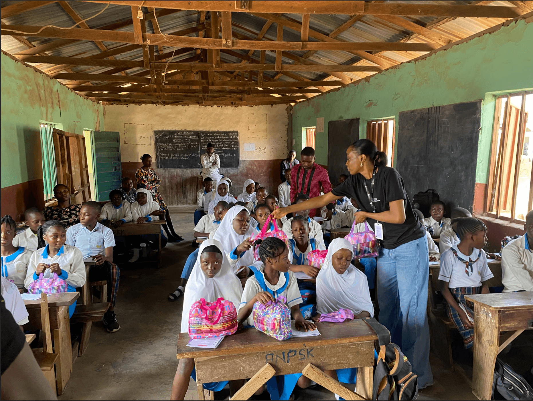 CFO volunteer distributing hygiene kits to students during Project WASH